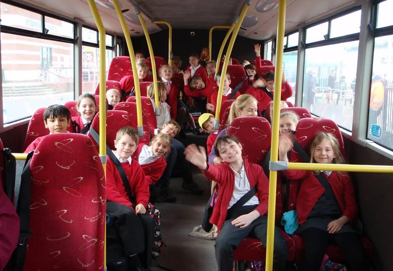 Picture of school children on a coach heading on their residential trip