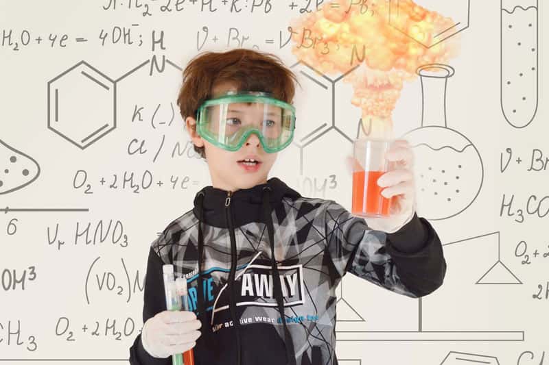 Photo of schoolboy undetaking explosive chemistry experiment