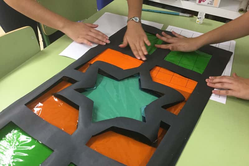 Photo of school children working on a piece of art and design